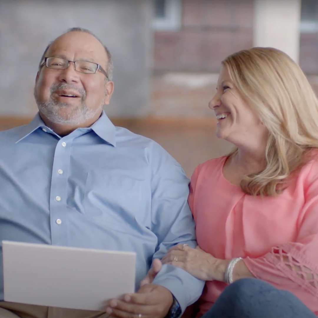 A husband and wife share a smile together. A husband and wife share a smile together.