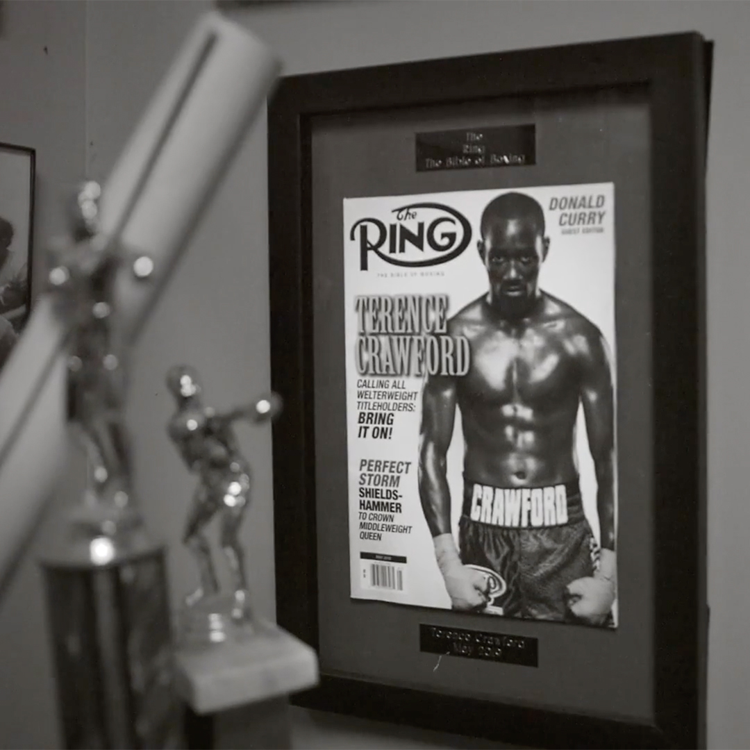 A framed magazine cover feating the famous boxed Terence Crawford sitting behind boxing trophies. A framed magazine cover feating the famous boxed Terence Crawford sitting behind boxing trophies.
